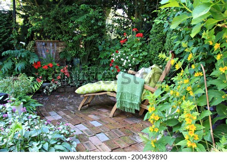 Comfortable lounge chair in a small private garden. Also available in vertical. 