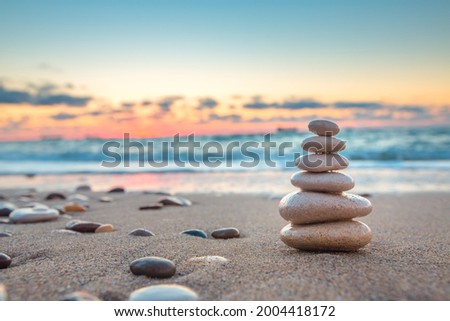 Stones balance on beach, sunrise shot. Zen meditation and relaxation Royalty-Free Stock Photo #2004418172