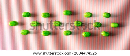 Cute watermelons on a striped red and white background. Summer fruit creative concept. Refreshing design.