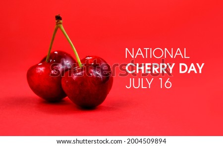 National Cherry Day stock images. Two ripe cherries isolated on a red background. Cherry Day Poster, July 16. Important day