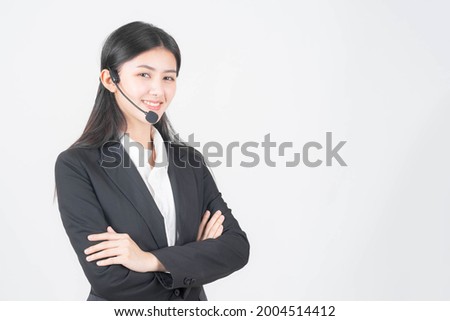 business customer support operator woman standing arms crossed speak with headphone on white background , Beautiful Asian woman officer talk with customer 