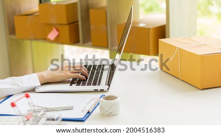 Starting a small business, SME entrepreneur, freelance, portrait of a young woman working at home, boxes, smartphones, laptops, online sales, marketing, packaging, SME, ecommerce and delivery concepts