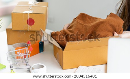 Starting a small business, SME entrepreneur, freelance, portrait of a young woman working at home, boxes, smartphones, laptops, online sales, marketing, packaging, SME, ecommerce and delivery concepts