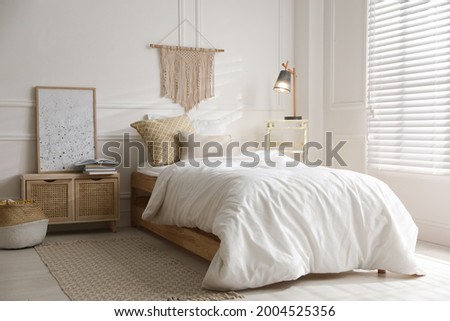 Comfortable bed with clean white linens indoors