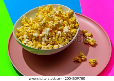 Movie theater popcorn on colorful neon pop art background