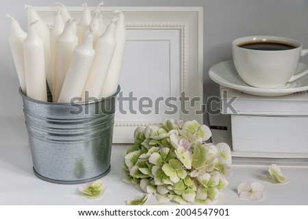 flowers, candles and a cup of coffee on a white background
