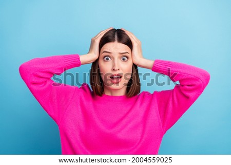 Photo of impressed shocked young lady wear pink pullover arms head open mouth isolated blue color background