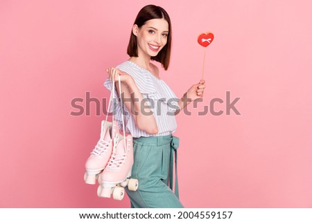 Profile side photo of young girl happy positive smile hold rollers heart figure isolated over pink color background