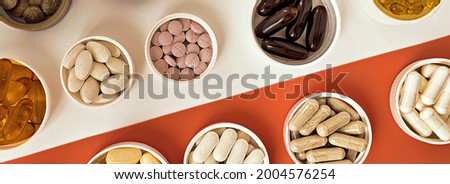 topview of multivitamin biologically active supplements. mental wellbeing and personal health banner Royalty-Free Stock Photo #2004576254