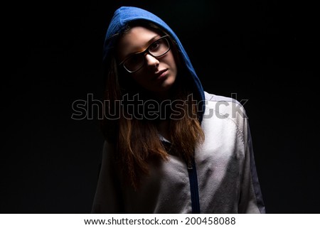 Serious teenager girl in shadow - photo portrait
