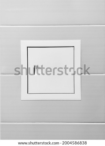White Maintenance hatch on a wall