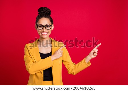 Photo of toothy teacher lady point empty space wear eyewear yellow cardigan isolated on vivid red color background
