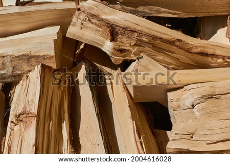 Pile of chopped firewood. Pile of chopped firewood close up. Selective focus.