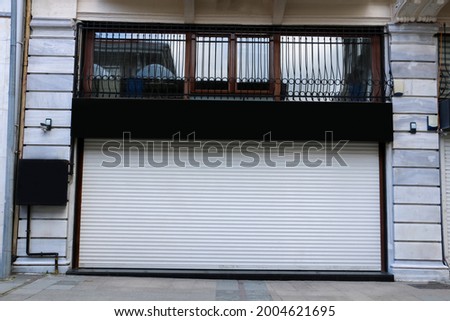 shopping with white shutters, shopping shop with black sign, blank sign. selective focus