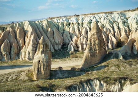 View of the ancient rocks houses in the valley during the sunset in Cappadocia, Turkey