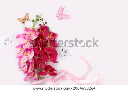 Holiday concept with flowers, spring or summer composition, still life, banner, flat lay of delicate orchid flowers with place for text. Greeting card for mother's day, women's day,