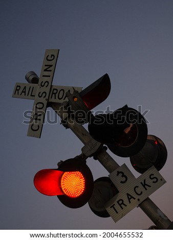 Railroad crossing with red light