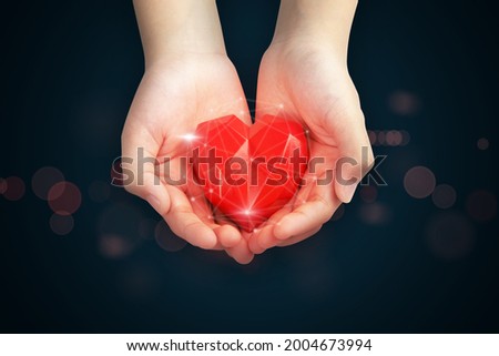 Hand holding red heart shape in hand with medical icon network connection modern virtual screen interface, service mind and medical technology network concept.