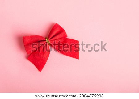 Red bow on a pink background.