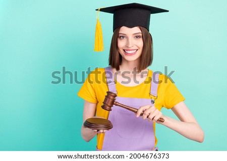 Photo of young happy charming woman hold hands hammer judge graduate isolated on pastel teal color background