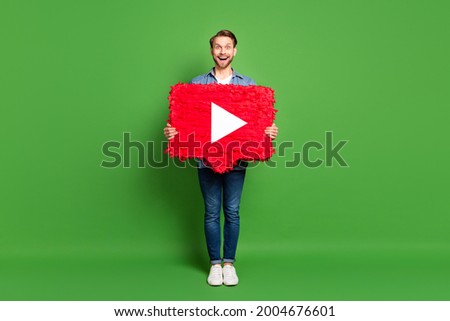 Full length body size photo of man keeping social media icon smiling isolated vivid green color background