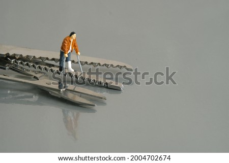 Miniature people toy figure photography. A men broken bones men walking with stick above on surgical equipment. Image photo