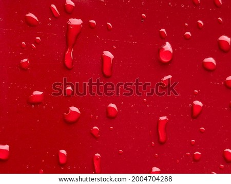 Isolated water drops on Red Painted surface