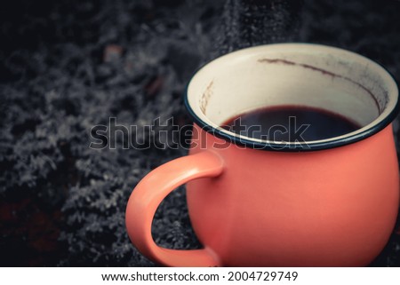 orange mug coffee on dark grass color. drink photography