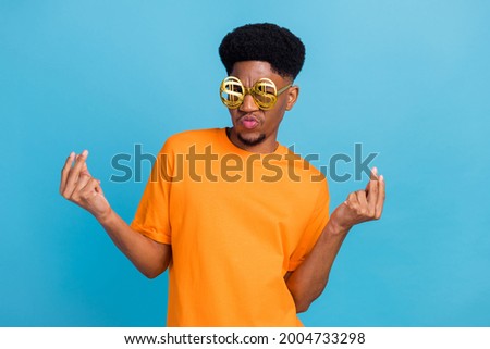 Portrait of attractive cool funky guy wearing money sign specs having fun posing isolated over bright blue color background