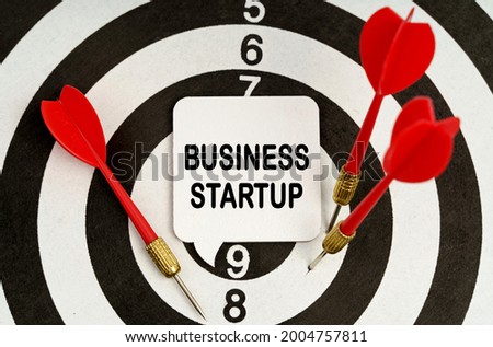 Business and economy concept. There is a sign on the target that says - BUSINESS STARTUP