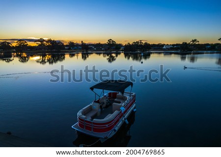 Pontoon Boat for hire on Ohmas Bay at the Big 4 Holiday Park in Forster-Tuncurry. Royalty-Free Stock Photo #2004769865