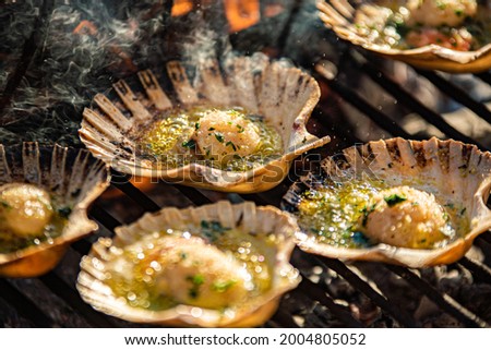 Detail of tasty Scallops on the grill with smoke, cooking scallops Royalty-Free Stock Photo #2004805052