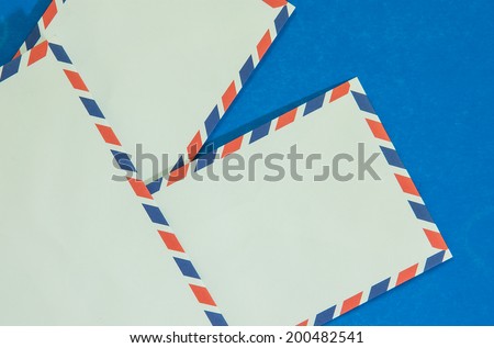 Three Air mail envelope interpolate on blue background.