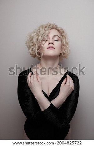 Headshot of gorgeous attractive young lady with curly hair smiling. Marilyn Monroe.