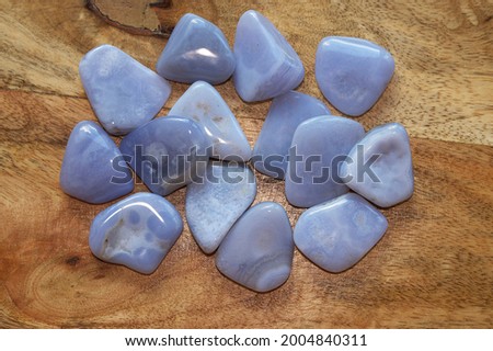 Top view of chalcedony gemstones on a wooden surface Royalty-Free Stock Photo #2004840311