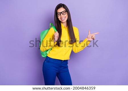Photo of sweet young lovely woman smile point finger empty space sale wear bag isolated on purple color background