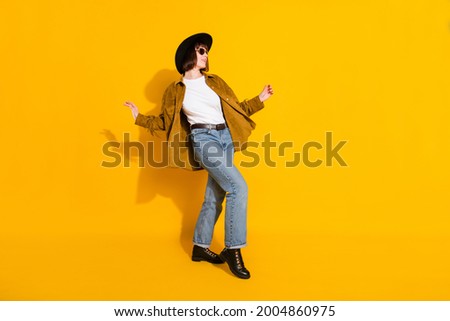 Photo of charming cute young lady wear cowgirl outfit dark glasses headwear dancing walking isolated yellow color background Royalty-Free Stock Photo #2004860975