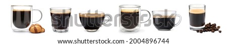 Glasses and cups of hot espresso on white background Royalty-Free Stock Photo #2004896744