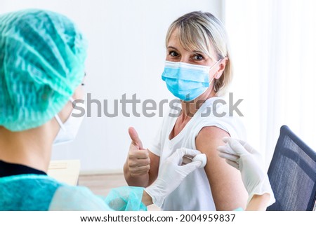 Women wearing masks getting vaccinated. Concept of coronavirus, vaccination elderly woman mask who approved covid-19 vaccination at hospital. Female doctor immunizes elderly patients against the virus Royalty-Free Stock Photo #2004959837