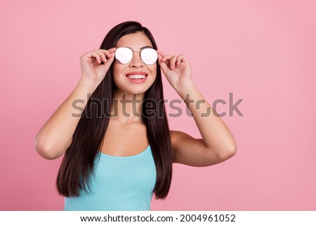 Photo of cool nice long hairdo lady look empty space wear spectacles blue top isolated on pastel pink color background