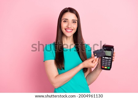 Photo of young woman happy positive smile make payment atm credit card shop isolated over pink color background