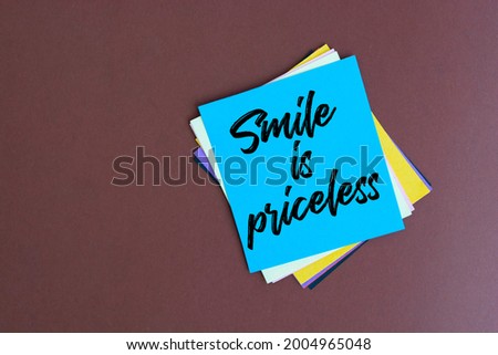 Text smile is priceless on the short note texture background