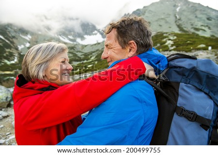 Senior tourist couple hiking and taking selfie at the beautiful mountains