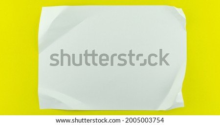 White sheet paper on yellow paper background copy space for your text advertising.