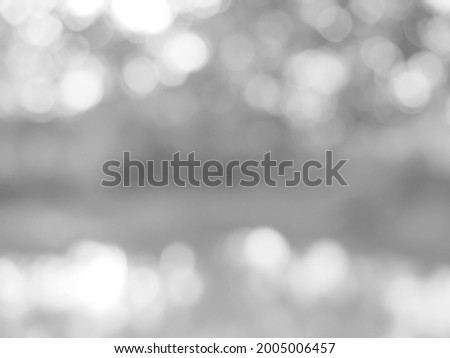 The glowing white bokeh image can be used as a background illustration or to add text to an advertisement.