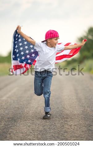 Happy adorable little boy smiling and waving American flag outside in motion. Smiling child celebrating 4th july - Independence Day