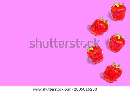 Strawberry. A pattern of strawberries on a colored background. Whole fruits, flat lay