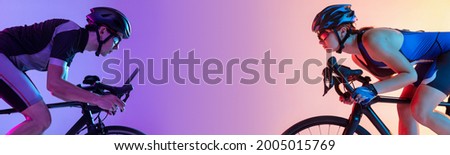 Bicycle race. Sport collage. Two sportsmen, man and woman cyclists posing isolated on gradient purple background. Copy space for ad, text Royalty-Free Stock Photo #2005015769