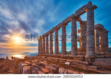 Greece Cape Sounio. Ruins of an ancient temple of Poseidon, Greek god of the sea, on sunset. Shot of temple ruins on sunset. Tourist landmark of Attica, Sounion, Greece