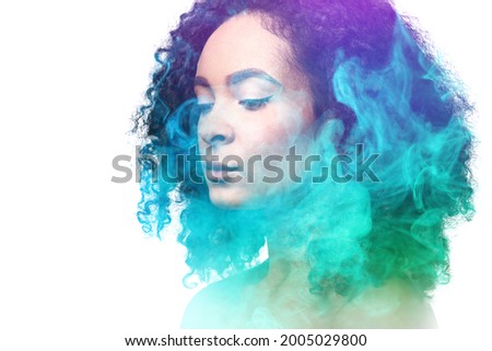 Beautiful African-American woman and her energy field on white background